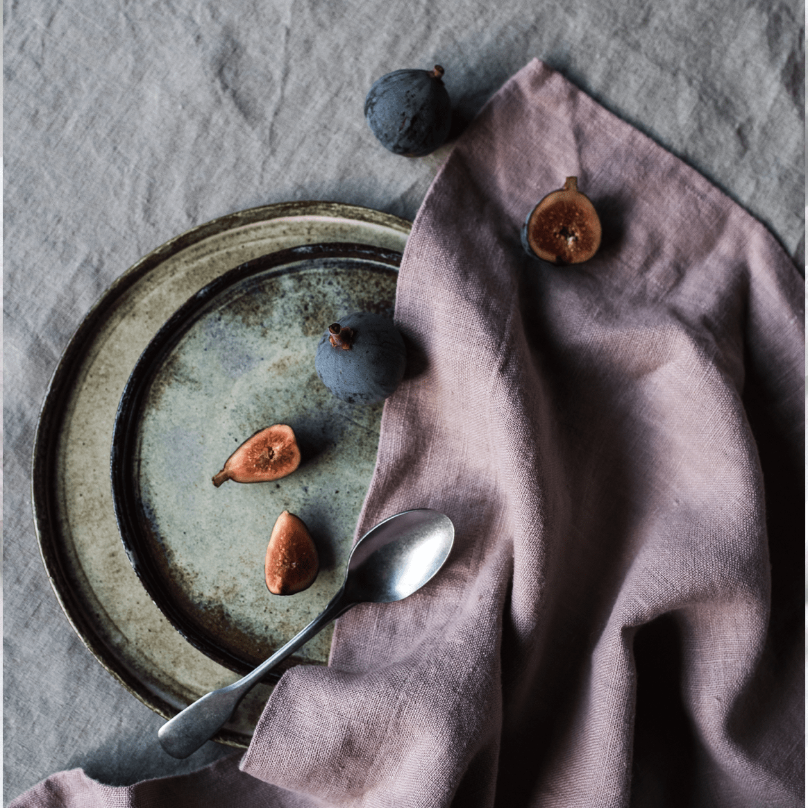 dusk colored table napkin partially covers a plate