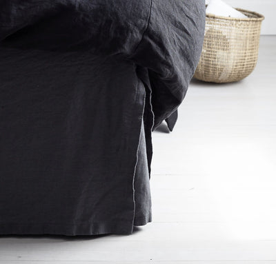 bed detail of 100% linen bedskirt heavyweight Orkney linen fabric charcoal dark grey color