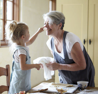 adult and child wearing 100% linen pinafore aprons aqua light blue dark grey colors