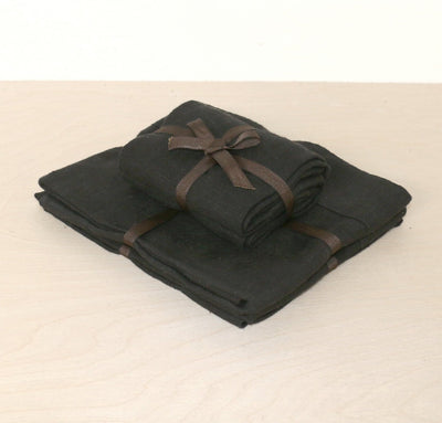 folded stack of 100% linen powder room towel set hand towels wash cloths heavyweight Orkney linen fabric antimicrobial fast drying black color