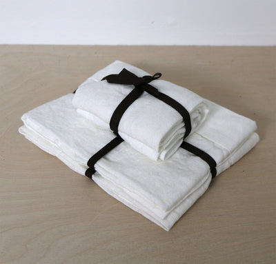 folded stack of 100% linen powder room towel set hand towels wash cloths heavyweight Orkney linen fabric antimicrobial fast drying off-white white color