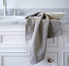 bathroom scene with 100% linen hand towel heavyweight Orkney linen fabric antimicrobial fast drying natural light brown beige tan color