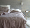 bedroom scene with 100% linen Cal King bed linens bed-in-a-bag duvet cover pillow shams bedskirt summer cover sheets rose light pink blush off-white white color