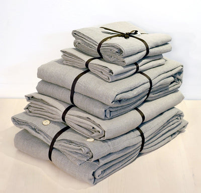 folded stack of 100% linen queen bed-in-a-bag set with duvet pillow shams summer cover flat sheets heavyweight Orkney linen fabric natural light brown beige tan colors