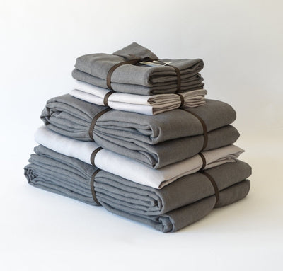 folded stack of 100% linen queen bed-in-a-bag set with duvet pillow shams summer cover flat sheets heavyweight Orkney linen fabric charcoal dark grey light grey colors