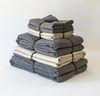folded stack of 100% linen queen bed-in-a-bag set with duvet pillow shams summer cover flat sheets heavyweight Orkney linen fabric charcoal dark grey natural light brown beige tan colors