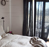 bedroom scene with 100% linen curtains heavyweight Orkney fabric breezy slightly sheer light filtering black color