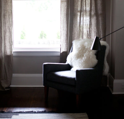 chair next to 100% linen curtains heavyweight Orkney fabric breezy slightly sheer light filtering natural light brown beige tan color