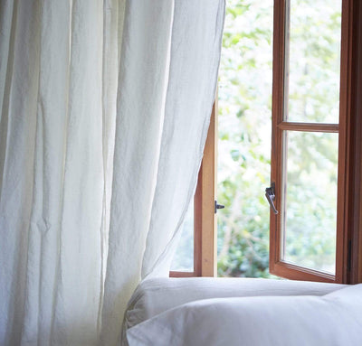 bedroom scene with 100% linen curtains heavyweight Orkney fabric breezy slightly sheer light filtering off-white cream color