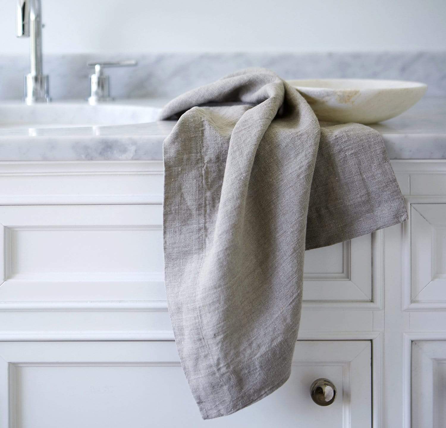 bathroom scene with 100% linen hand towel heavyweight Orkney linen fabric antimicrobial fast drying natural light brown beige tan color