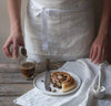 white linen bakers chef's style linen apron with pockets. White tea towel and coffee pastry scene