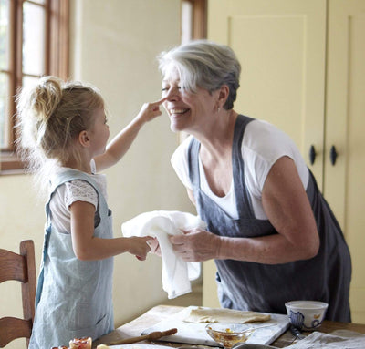 picture of child and woman wearing 100% linen pinafore apron light blue aqua grey charcoal colors