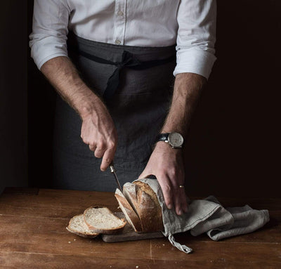 man wearing 100% linen apron heavyweight Orkney linen fabric charcoal dark grey color