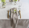 dining table scene with 100% linen napkin smooth texture lightweight linen fabric un-dyed natural beige tan color