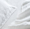 closeup detail of 100% linen raw edge bed set king queen twin sizes with summer cover blanket pillow cases pure white color