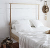 bedroom scene with 100% linen raw edge bed set with summer cover blanket pillow cases pure white color