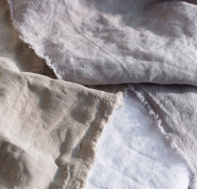 closeup detail of 100% linen table runner raw edge detail natural light brown beige tan colors