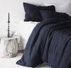 bedroom scene with 100% linen duvet comforter cover smooth texture mid-weight St. Barts linen fabric twin queen king calking sizes ink navy color